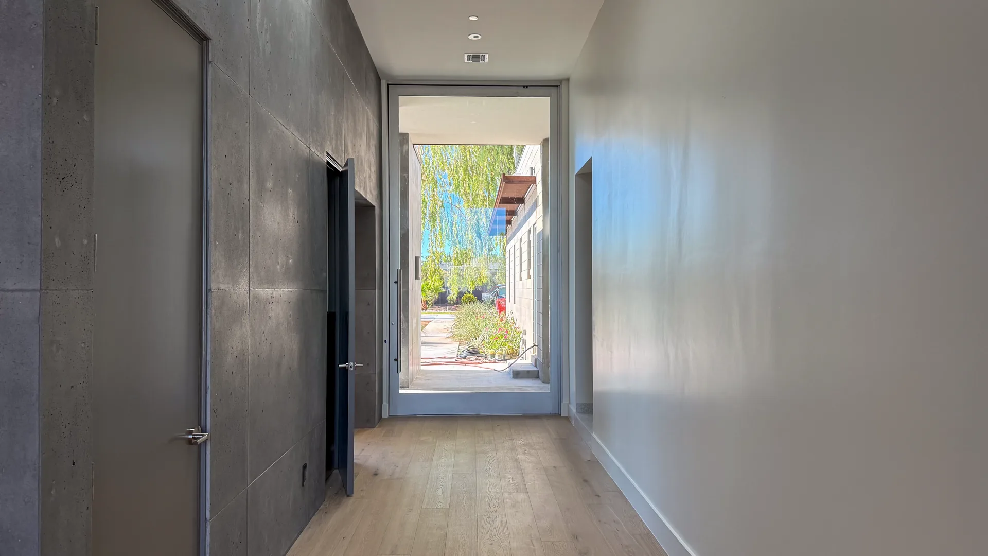 Gallery hall with concrete feature wall and full-height glass