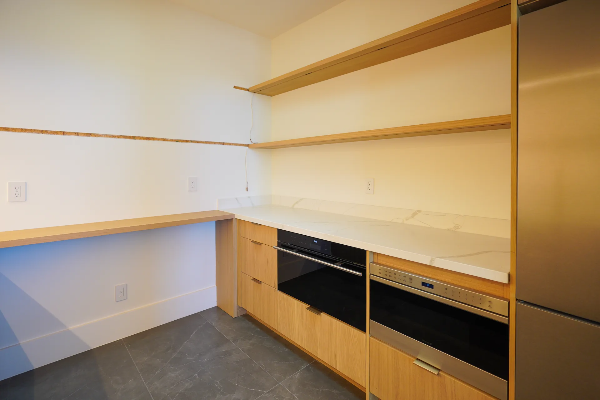 Butler's pantry appliance wall with wall ovens
