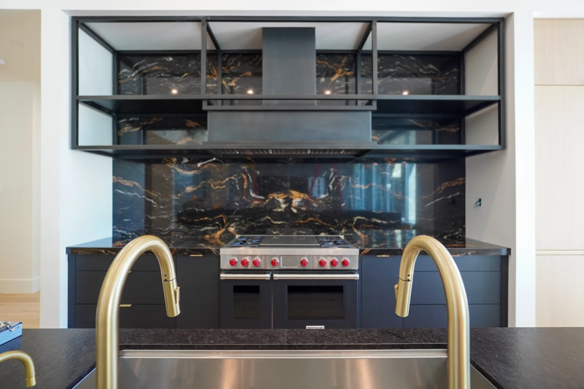 Range wall with open steel shelving and dramatic stone backsplash