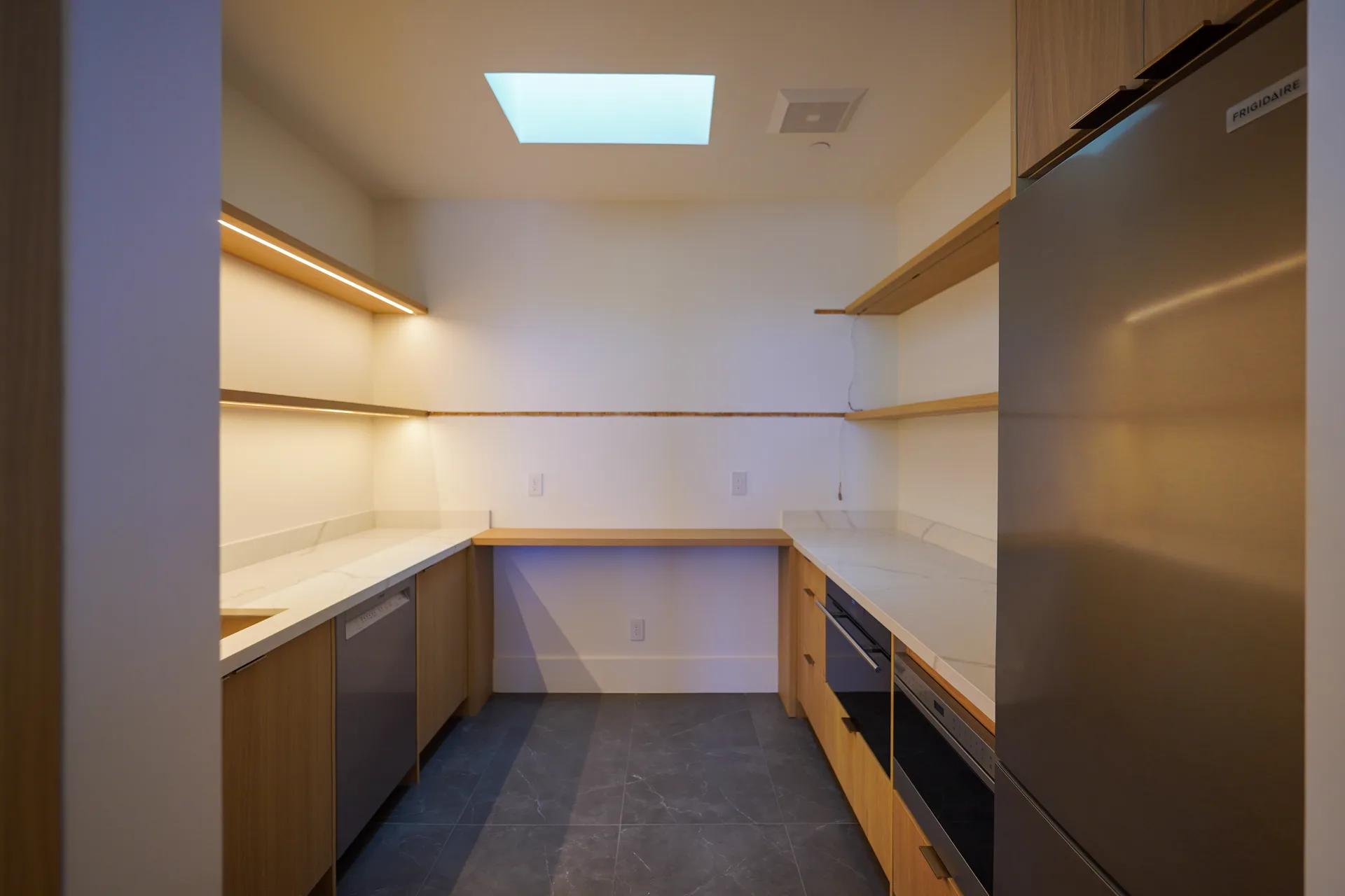 Butler's pantry with oak shelving and skylight