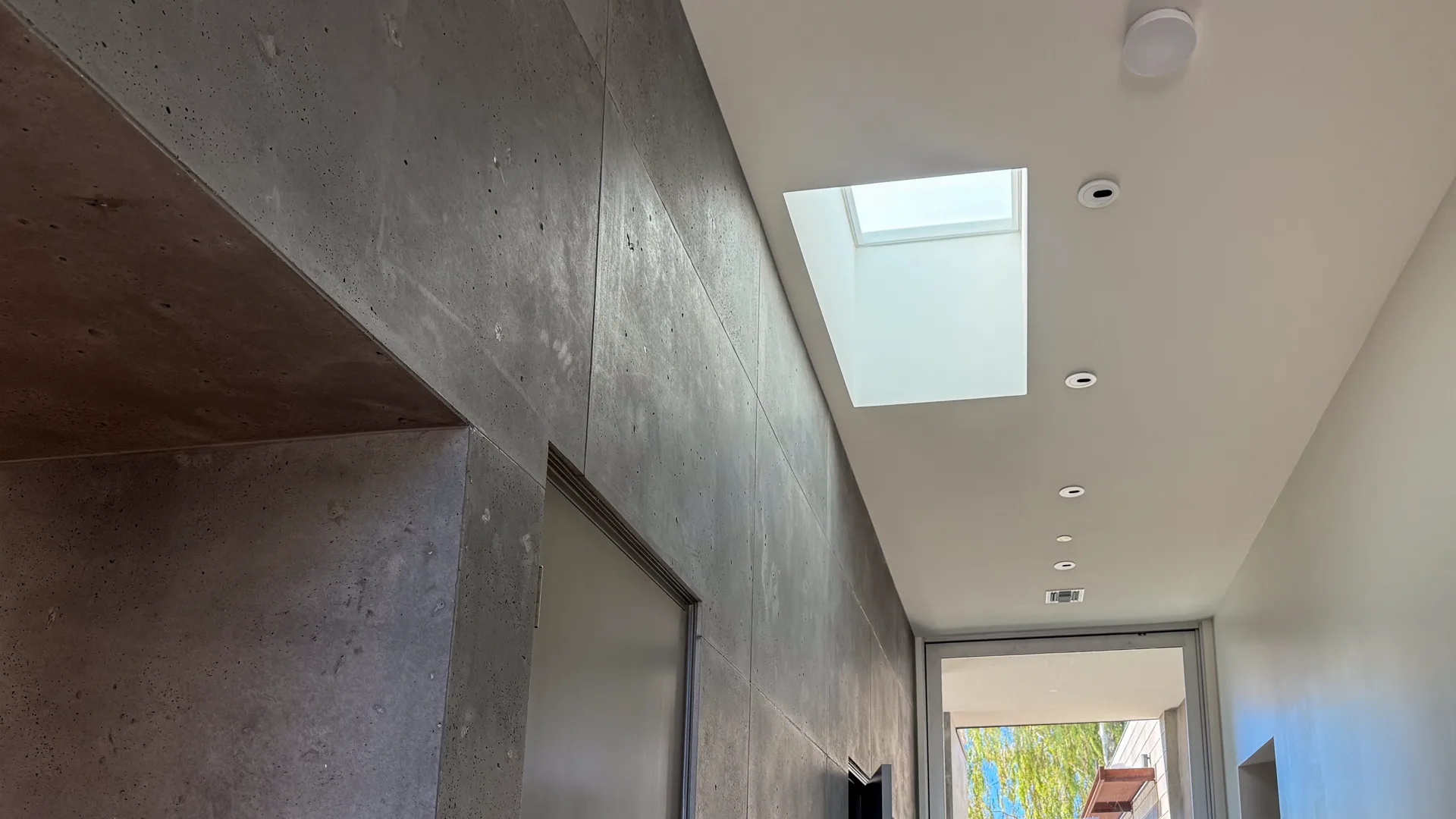Skylight above the concrete gallery wall