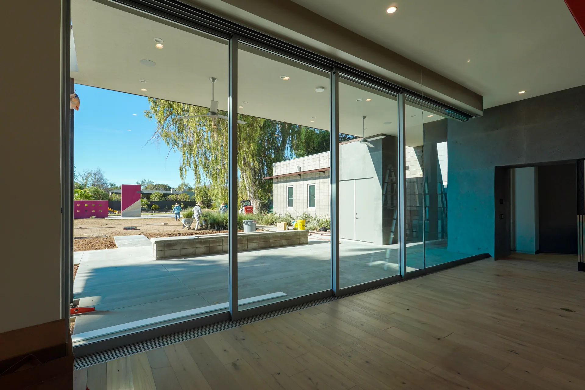 Family room sliding glass walls opening to the covered patio