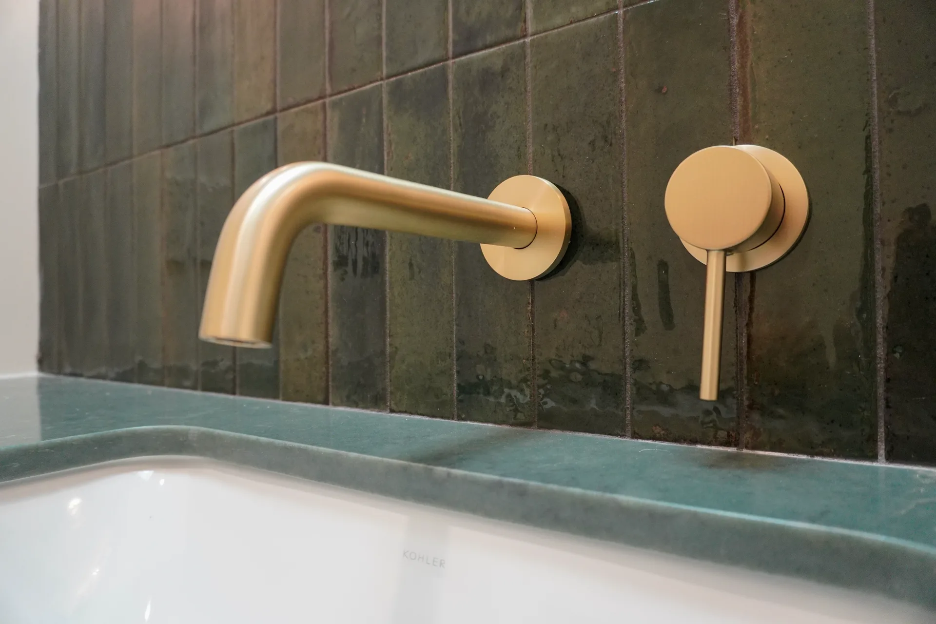 Wall-mounted brass faucet over the undermount sink